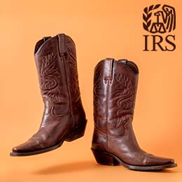 Two isolated brown leather cowboy boots dancing in front of an orange background. Dark brown IRS logo. 