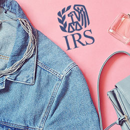 Denim jacket, perfume bottle, blue purse and blue IRS logo. 