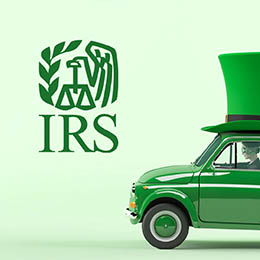 Light green background; left side green IRS logo; half of small green car (driver's side, person driving) with half of Lepprechaun's green hat on top
