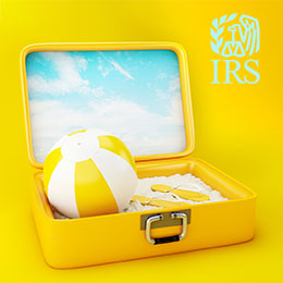 Open yellow suitcase, top lid has blue sky and clouds; inside suitcase a yellow and white beach ball, white and yellow flip flops on top of white sand; aqua IRS logo on upper right corner