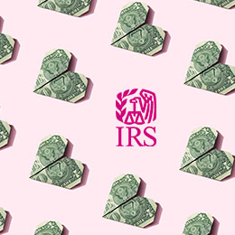 Rows of dollar bills folded into hearts. One space in the row is replaced by a magenta IRS logo. 