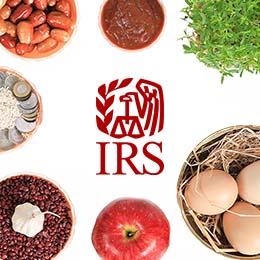 Assorted Nowruz table items including: dates, eggs, garlic, grass, coins and samanu. Red IRS logo. 